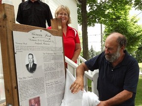 Maureen Agar stands next to Travis Postil former husband of Barb Postil-Box as he unveils the new plaque in Victoria Park July 1.(Shaun Gregory/Huron Expositor)