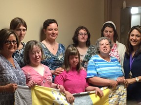 A group of participants from Ruth's Place, a private day program in rural Lambton County, dropped by the Women's Interval Home in Sarnia recently to deliver a quilt they made. Back row, from left, Yvonne Weys, Sarah Myers, Danielle Debuque and Mandie Wildschut. Front, from left, Kathy McNally, Laura van Wyk, Ashley Canton, Darlene Jones and Angie Marks, director of services for the Women's Interval Home. Handout/Sarnia Observer/Postmedia Network