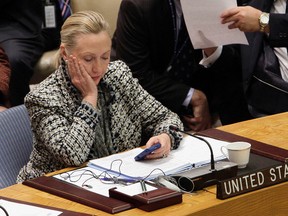 In this March 12, 2012 file photo, then-Secretary of State Hillary Rodham Clinton checks her cellphone after her address to the Security Council at United Nations headquarters. (AP Photo/Richard Drew, File)