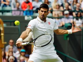 Novak Djokovic of Serbia returns to Sam Querrey of the U.S. during their men's singles match on day six of the Wimbledon Tennis Championships in London, Saturday, July 2, 2016. (AP Photo/Alastair Grant)