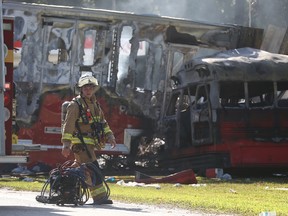 Wakulla County first responders work on the scene of an accident on Saturday, July 2, 2016, in Wakulla, Fla. The Florida Highway Patrol says a bus and tractor-trailer collided on a highway in the Panhandle. Florida Highway Patrol Capt. Jeffrey Bissainthe says the bus was carrying between 30 and 35 passengers and was from Georgia. (Joe Rondone /Tallahassee Democrat via AP)