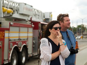 Maggie and Gerry McQuillan who own the Minuteman Press franchise in Hyde Park look at the total devastation of their business and all of their neighbours after a Thursday afternoon fire in London, Ont. on Friday July 1, 2016. 
Mike Hensen/The London Free Press/Postmedia Network
