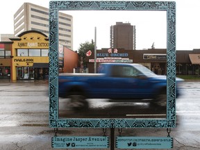 A truck passes by Naomi Pahl's photo frame during a press conference launching the public engagement portion of the City of Edmonton's Imagine Jasper project in Edmonton on Wednesday, June 29, 2016. IAN KUCERAK / Postmedia Network
