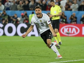 Germany's Jonas Hector celebrates after scoring the winning penalty during the Euro 2016 quarterfinal match between Germany and Italy at the Nouveau Stade in Bordeaux, France on Saturday, July 2, 2016. (Antonio Calanni/AP Photo)