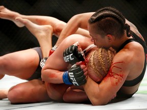 Amanda Nunes (right) wraps up Valentina Shevchenko during their UFC 196 women's bantamweight mixed martial arts match in Las Vegas on Saturday, March 5, 2016. (Eric Jamison/AP Photo)