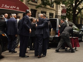 Family and friends embrace each other after they carried Elie Wiesel's coffin during a private service for the Nobel laureate and Holocaust survivor at the Fifth Avenue Synagogue in New York, Sunday, July 3, 2016. Wiesel shared the harrowing story of his internment at Auschwitz as a teenager through his classic memoir "Night," one of the most widely read and discussed books of the 20th century. (AP Photo/Andres Kudacki)