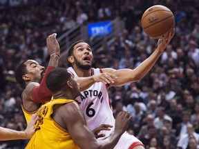 Toronto Raptors guard Cory Joseph (6) drives to the net past Cleveland Cavaliers centre Tristan Thompson (13) during NBA action in Toronto on Friday, February 26, 2016. (THE CANADIAN PRESS/Nathan Denette)