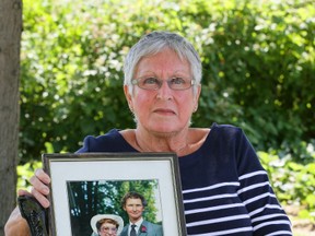 Mary Ellen McDougall holds a wedding photograph of her and her husband Neil McDougall at her home on Saturday near Durham, Ont. McDougall's husband Neil McDougall disappeared on October 12, 1985. The OPP recently announced a $50,000 reward for information that helps solve the cold case. (James Masters/The Owen Sound Sun Times/Postmedia Network)