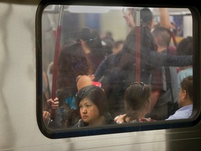Riders on a crowded subway car. (STAN BEHAL, Toronto Sun)