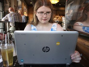 Daisy Barrette, social media manager of Sudo, a new non-profit organization, works on her laptop computer at the Common Market Coffee shop. (Julia Balakrishnan, For The Whig-Standard)
