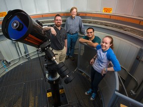 University of Alberta physicists, right to left, Bailey Tetarenko, Arash Bahramian, Craig Heinke, Gregory Sivakoff and­ Robin Arnason, not pictured, who is now at Western University, led an international group of collaborators in the discovery of a black hole that suggests there may be vast numbers of black holes in our galaxy that have gone unnoticed until now.