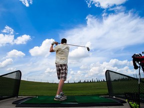 Dustin Perepelecta practises his swing at Mill Woods Golf Course on Saturday. (Codie McLachlan)
