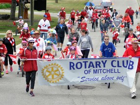 The Rotary Club of Mitchell led the pied piper parade from the Mitchell municipal office to the Lions Park, with Rotarians Carolyn Deck and Charles Fitzsimmons carrying the banner into the park. ANDY BADER MITCHELL ADVOCATE