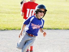 Dominic Marshall of the Mitchell Major Rookie baseball team rounds third base during WOBA league action at home to Clinton last Monday, June 27, a 25-6 victory. ANDY BADER MITCHELL ADVOCATE