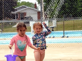 Danika (left) and Mikaela Clements enjoyed their first of many trips this summer to the splash pad in Mitchell June 24, after it opened a few days earlier. GALEN SIMMONS MITCHELL ADVOCATE