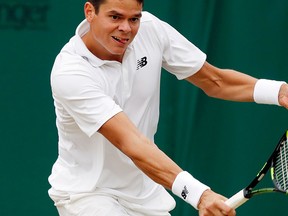Milos Raonic of Canada returns to David Goffin of Belgium during their men's singles match on day eight of the Wimbledon Tennis Championships in London, Monday, July 4, 2016. (AP Photo/Ben Curtis)