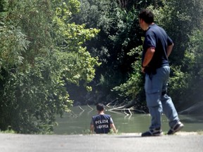 Italian Police inspect the banks of the Tiber river in Rome where the body of a young man was found, Monday, July 4, 2016. Italian authorities on Monday were investigating the disappearance of a Wisconsin student in Rome a day after he arrived in the Italian capital. Police reported the discovery of the body of a young male in the Tiber river in Rome but stressed no identification of the corpse had been made, and thus it was impossible to say if the development might be part of the case of the missing student (AP Photo/Andrew Medichini)