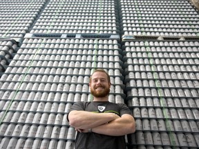 Gavin Anderson of Anderson Craft Ales taps a sample of his first brew at their Elias Street location Monday. He hopes to be selling suds by July 23. (MIKE HENSEN, The London Free Press)