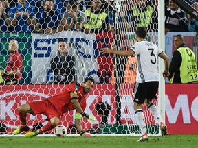 Germany's Jonas Hector scores the winning penalty past Italy goalkeeper Gianluigi Buffon during the Euro 2016 quarterfinal match at the Nouveau Stade in Bordeaux, France, on Saturday, July 2, 2016. (Martin Meissner/AP Photo)