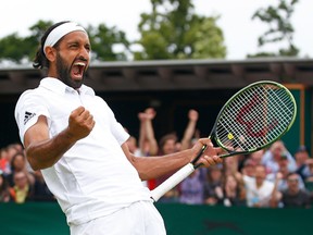 Adil Shamasdin of Canada celebrates after a Wimbledon first-round men’s doubles win over Pablo Cuevas and Marcel Granollers July 4, 2016 in London. (Julian Finney/Getty Images)