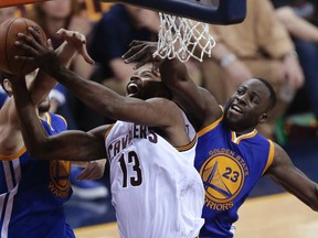 Cleveland Cavaliers centre Tristan Thompson (13) drives on Golden State Warriors defenders Klay Thompson, left, and Draymond Green (23) during Game 4 of the NBA Finals in Cleveland Friday, June 10, 2016. (AP Photo/Tony Dejak)