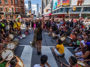 Black Lives Matter protesters sit on the ground to halt the annual Pride Parade. (THE CANADIAN PRESS)