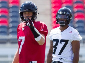 Redblacks QB Trevor Harris (left) shouts out instructions while Mossis Madu Jr. (right) looks on during practice at TD Arena in Ottawa on Monday, July 4, 2016. (Darren Brown/Postmedia)