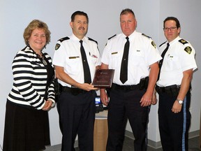 St. Joseph's Health Care London president and CEO Gillian Kernaghan, left, presents the 2015 Community Partner of Distinction Award to Elgin OPP detachment commander Brad Fishleigh, Sgt. Greg Dafoe and Staff Sgt. Al Gordon. The detachment was recognized by the hospital network for their efforts to address mental health issues in the community.