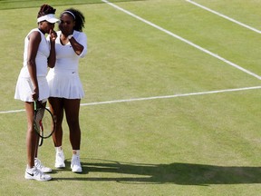 Venus Williams, left, and Serena Williams of the U.S speak during their women's doubles match against Andrea Hlavackova and Lucie Hradecka of the Czech Republic on day nine of the Wimbledon Tennis Championships in London, Tuesday, July 5, 2016. (AP Photo/Kirsty Wigglesworth)