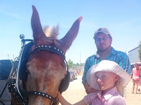 The Lucknow Strawberry Summerfest saw a wide variety of events, vendors, activities and contests during the June 22-26, 2016 festival. PICTURED: It was a sunny day for a wagon ride with Cedric Scott of Kinloss Grand Maple Farms (at back). Isabelle Grein of Sweden got a closer look at one of the mules pulling the wagon. (Troy Patterson/Kincardine News and Lucknow Sentinel)