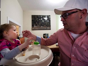 Alex Repetski, right, gives his two-year-old daughter Gwenevere oil-based medical marijuana to help control her seizures in Toronto on April 7, 2015. Parents of children suffering from epilepsy say a recent move by Canadian border agents to seize shipments of medical marijuana oil from an American company could have a catastrophic effect on their children's health. Alex Repetski uses Charlotte's Web as part of the marijuana oil he concocts at his Thornhill, Ont., home for his four-year-old daughter, Gwen, who lives with epilepsy that has left her developmentally delayed. THE CANADIAN PRESS/Nathan Denette