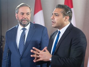 Freed Canadian journalist Mohamed Fahmy speaks to reporters as NDP Leader Tom Mulcair looks on after their meeting,  Tuesday, October 13, 2015 in Toronto. THE CANADIAN PRESS/Ryan Remiorz