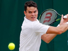 Milos Raonic returns to David Goffin during their men's singles match at the Wimbledon Tennis Championships in London on Monday, July 4, 2016. (Ben Curtis/AP Photo)