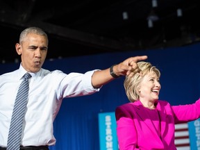US President Barack Obama and Democratic presidential candidate Hillary Clinton arrive at a campaign event in Charlotte, North Carolina, on July 5, 2016.President Obama threw his full weight behind Hillary Clinton's bid to succeed him, extolling the experience and fighting spirit of his former secretary of state at their first joint campaign appearance.