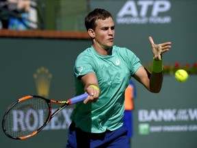 Vasek Pospisil returns a shot to Jared Donaldson during their match at the BNP Paribas Open Friday, March 11, 2016, in Indian Wells, Calif. (AP Photo/Mark J. Terrill)