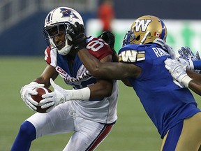 Winnipeg Blue Bombers defender Chris Randle gets his hands up on Montreal Alouettes receiver Duron Carter during CFL action at Investors Group Field in Winnipeg on Friday, June 24, 2016. (Kevin King/Winnipeg Sun/Postmedia Network)