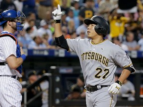 Pittsburgh Pirates’ Jung Ho Kang (27) reacts as he crosses the plate in front of New York Mets catcher Kevin Plawecki after hitting a two-run home run Tuesday, June 14, 2016, in New York. (AP Photo/Julie Jacobson)