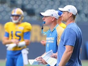 Winnipeg Blue Bombers offensive coordinator Paul LaPolice (left) and head coach Mike O'Shea watch play during CFL football practice in Winnipeg, Man. Tuesday July 5, 2016.