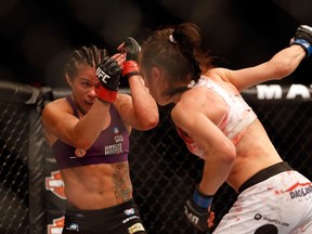 Claudia Gadelha (left) defends a punch from Joanna Jedrzejczyk in their women's strawweight bout during the UFC Fight Night event at the at U.S. Airways Center in Phoenix on Dec. 13, 2014. Gadelha faces Jedrzejczyk at the Ultimate Fighter Finale in Las Vegas on Friday. (Christian Petersen/Getty Images/Files)