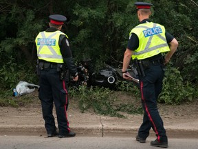 Police investigate at the scene of a fatal motorcycle crash along Bellamy Hill near 99 Avenue, in Edmonton on Tuesday July 5, 2016.