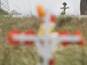 Two crosses from previous accidents stand at the intersection of Rochester Road and County Road 46 on Sunday, June 26, 2016, where two motorcyclists died after a collision with a minivan Saturday evening. DAX MELMER / WINDSOR STAR