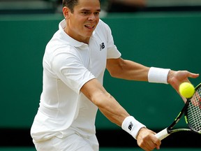 Milos Raonic of Canada returns to Sam Querrey of the U.S during their men's singles match on day ten of the Wimbledon Tennis Championships in London, Wednesday, July 6, 2016. (AP Photo/Alastair Grant)