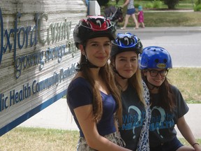 Students from Oxford County's What the Health? program show off bicycle helmets donated by local businesses and given out at bike rodeos across the county.  From left Callie Symmer, Shelby Hehn and Alexia Shank-Pippel. (HEATHER RIVERS, Sentinel-Review)