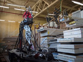 Jonathan Tippett is seen controlling "Prosthesis: the anti-robot" at a warehouse in Vancouver, Thursday, June, 30, 2016. THE CANADIAN PRESS/Jonathan Hayward
