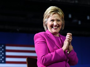 Democratic presidential candidate Hillary Clinton listens as President Barack Obama speaks about her during a campaign event at the Charlotte Convention Center in Charlotte, N.C., Tuesday, July 5, 2016. (AP Photo/Susan Walsh)