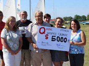 Samantha Reed/The Intelligencer
Helen Dowdell, executive director of Hospice Quinte, accepts a donation from regatta co-ordinator Brian Thomson, as she's surrounded by members of Hospice Quinte and the Bay of Quinte Yacht Club.