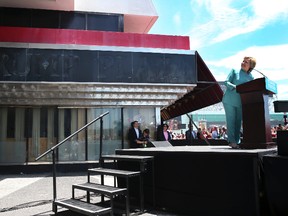 Democratic presidential candidate Hillary Clinton looks back at the faded sign of the former Trump Plaza as she speaks in Atlantic City, N.J., Wednesday, July 6, 2016. Trump Plaza closed permanently on Sept. 16, 2014. (AP Photo/Mel Evans)