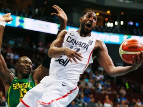 Canada's Tristan Thompson (right) goes under the basket as Senegal's Hamady Ndiaye defends during the Group A FIBA Olympic Qualifying match in Pasay city south of Manila, Philippines on Wednesday, July 6, 2016. (Bullit Marquez/AP Photo)