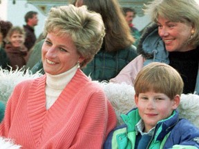 FILE - Princess Diana and her sons Harry and William (R) sit warmly wrapped up in a horse-drawn carriage in the resort of Lech in this March 27, 1994, file photo.