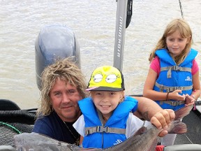 Todd Longley poses with A participant in one of Winnipeg's fish camps on the Red River. the youth angler reeled in 34-inch Channel Catfish.